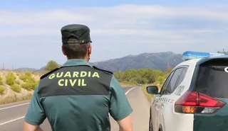 Un agente de la Guardia Civil junto a un vehículo en una carretera. FOTO GUARDIA CIVIL EP