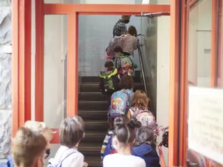 Niños entrando a un colegio. Foto de archivo