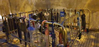 Los paraguas se fueron acumulando a la entrada al prohibirse pasar con ellos