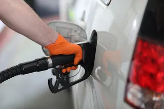 Un hombre echa gasolina a su coche.